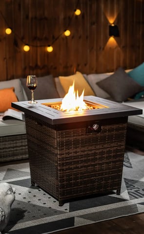 a patio table with a glass of wine and a glass of wine