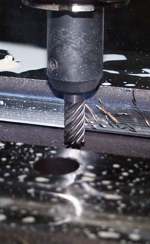 CNC Milling machine that is cutting through a piece of metal