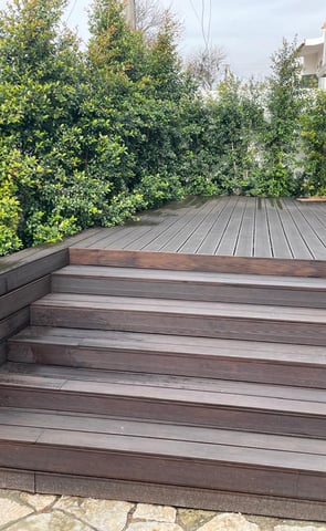 a wooden deck with a bench and a bench