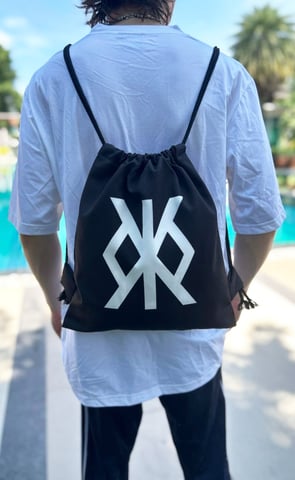 a man with a backpacker bag on his back, standing in front of a swimming pool