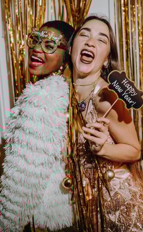 two women in masks and masks on a gold foil foil