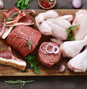 a cutting board with meat and vegetables on it