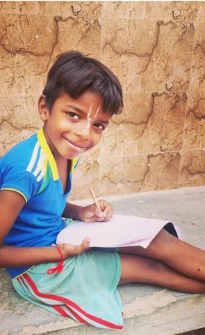 young boy doing home study