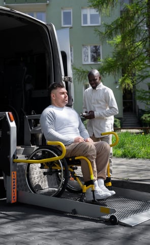 a man in a wheelchair patient transportation services