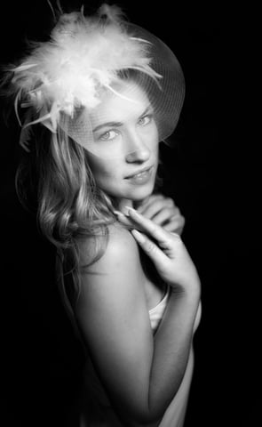 a woman in a hat with a feathered hat