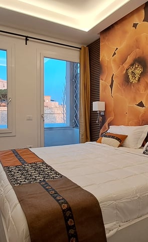 a bedroom with a large bed and a television