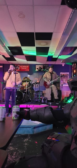 john and band on stage playing guitar