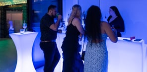 Three guests waiting at the LED glow bar to be served by the bartender at a party in Redland Bay.