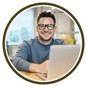 a man with glasses and a laptop computer