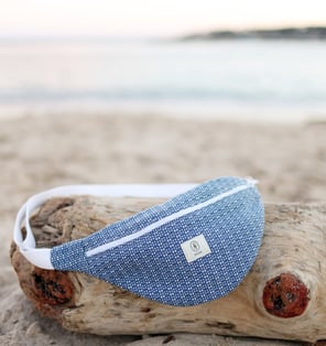 Sac banane ÉTOFÉ en tissu recyclé bleu, fait main sur la Côte d'Azur, posé sur une plage