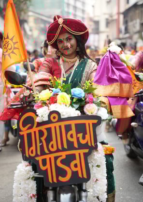 woman in maharastrian traditional outfit riding a motorbike in girgaon gudipadwa shobhayatra 2025