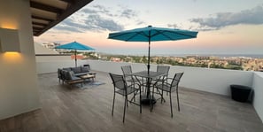 Patio with view on the sea tables and umbrellas