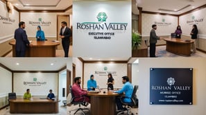 a group of people standing around a table with a sign that says roshan valley