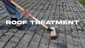 a person with a broom and a broom on a brick wall