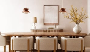 a dining room table with a vase of flowers, and chairs