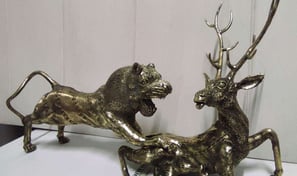 "Handcrafted brass sculpture of a lion hunting a deer-Qualified for export"