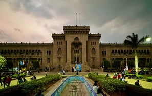 a large building with a fountain in front of it