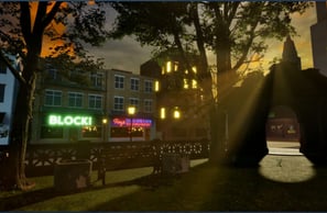 Coded Black gameplay screenshot showing a city scene and a park lit with rays of sunlight.