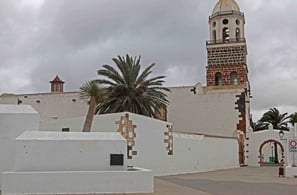 a clock tower with a clock tower in the background