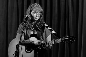 Moss.E playing guitar and singing on stage at Ramsgate Music hall