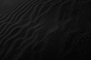 background image - wind waves on a black fine sand field