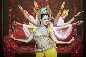 group of dancers performing in a show with red background