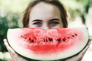 a person smiling from eating healthy
