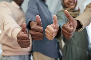 Four hands giving a thumbs up