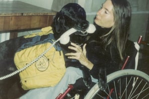 a woman in a wheelchair with a dog
