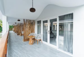 a balcony with a chair and a table