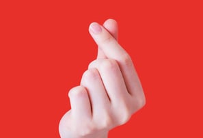 Hand forming a heart shape. Donate to Sixth Station Catholic Homeless Care