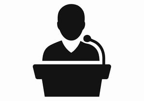 a man in a podium with a microphone