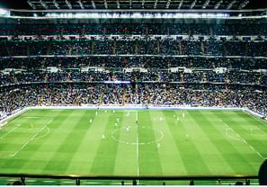 Wide view of a football stadium full of supporters