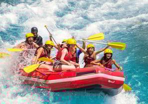 a group of people rafting down a river
