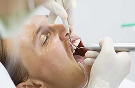 a man is getting his teeth cleaned