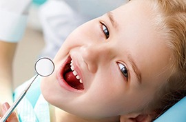 a child's smiling face at a dentist's office