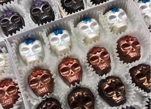 Handcrafted white, milk, and dark chocolates inspired by Day of the Dead featuring festive and traditional designs