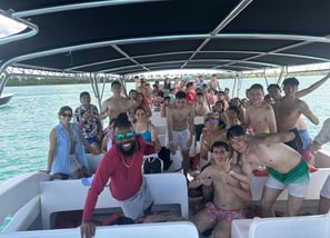 a group of people on a boat in the water
