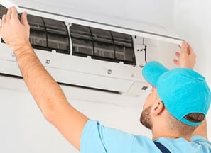 a man in a blue shirt is holding a blue hat