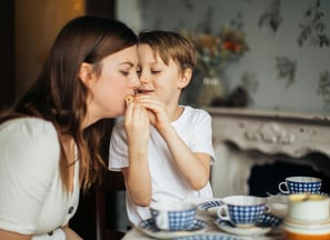 chid with autism eating with his mom