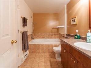 a bathroom with a tub and a toilet