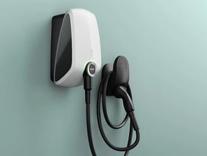 a white electric charger with a charging cord attached to it