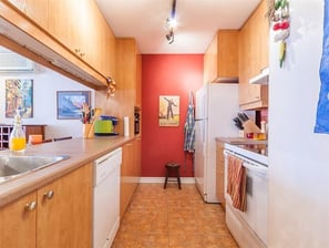a kitchen with a sink, refrigerator, and stove