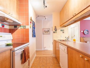 a kitchen with a stove top oven and a dishwasher