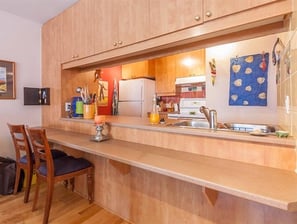 a kitchen with a table and chairs and a refrigerator