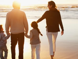 A family walking along a beach