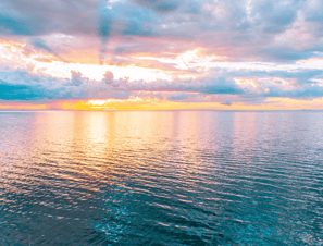 a view of sunset from the sea