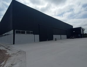 a large building with a large black building in the background