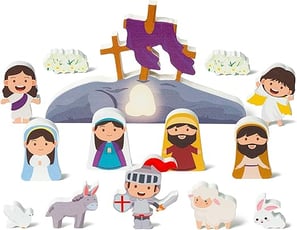 a group of wooden cutouts of Jesus and empty tomb