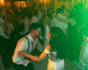 Bride and groom dancing to LuxeBand at their wedding with guests on the dance floor